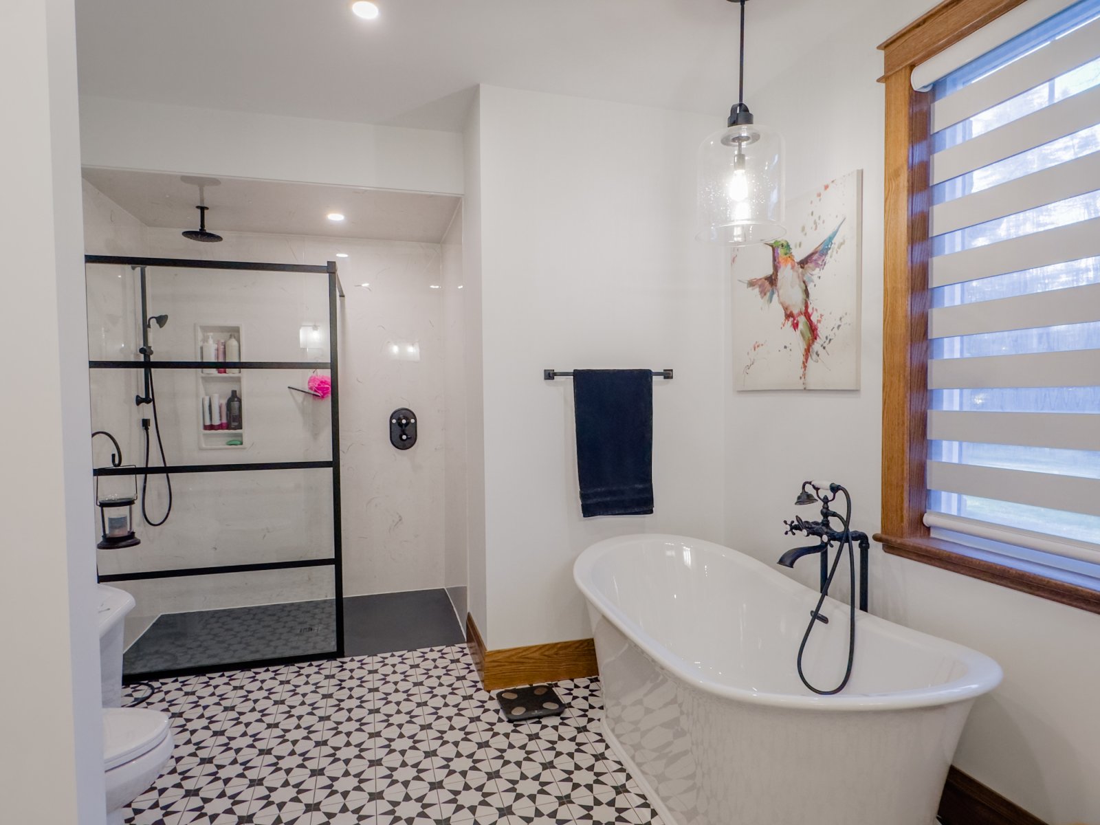 Spa ensuite with freestanding tub, walk-in shower and patterned tile