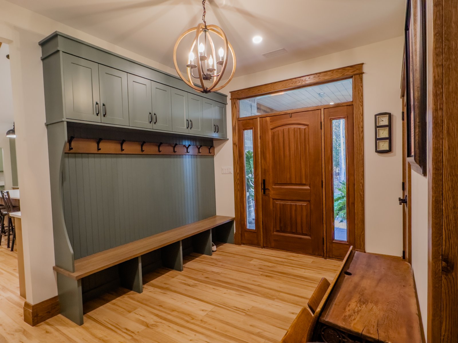 Custom mudroom with built-in bench, lockers and a solid wood door
