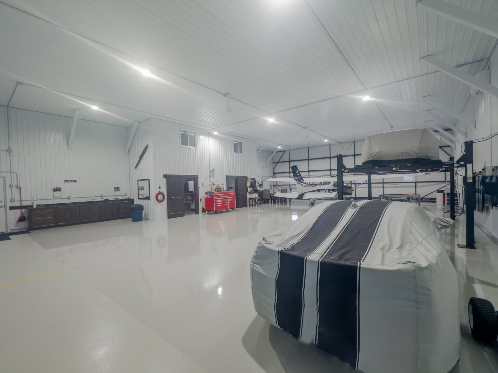 Hangar bay with stored aircraft, equipment and workbench
